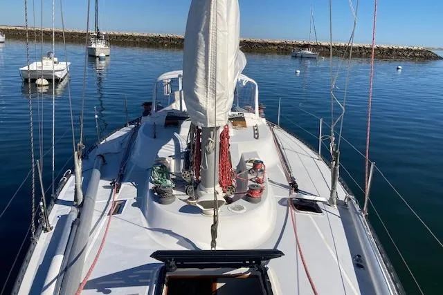 Slide: The Image of 1975 Tartan 41 sailboat on calm water, showcasing deck and rigging. - 5