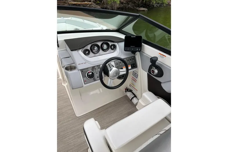 Slide: The Image of 2016 Sea Ray 270 Sundeck helm with modern controls and navigation system. - 5