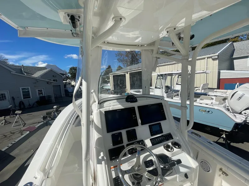 Slide: The Image of 2019 Regulator 23 boat cockpit with modern navigation equipment and steering wheel. - 12