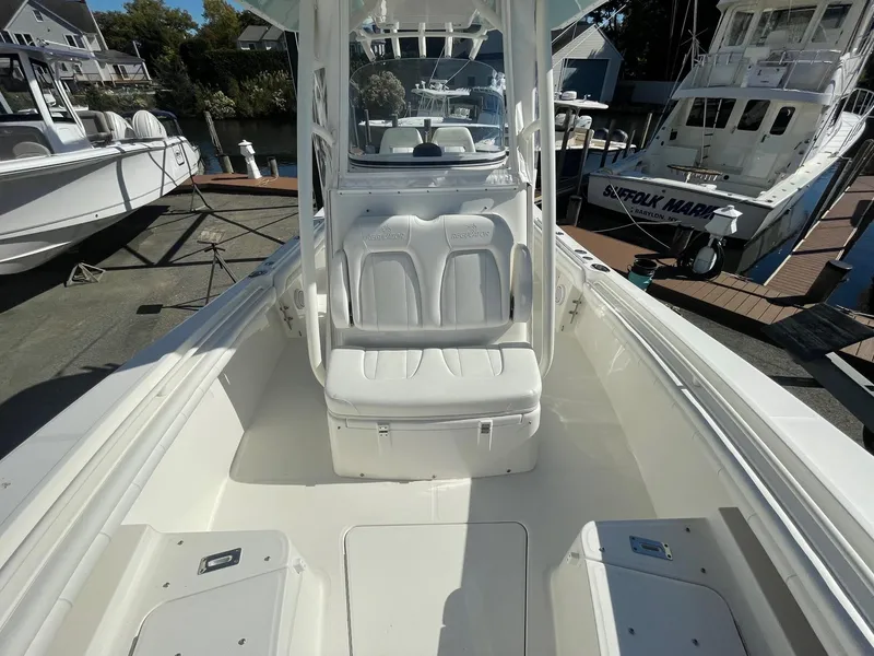 Slide: The Image of 2019 Regulator 23 boat interior with seating and console, docked at marina. - 20