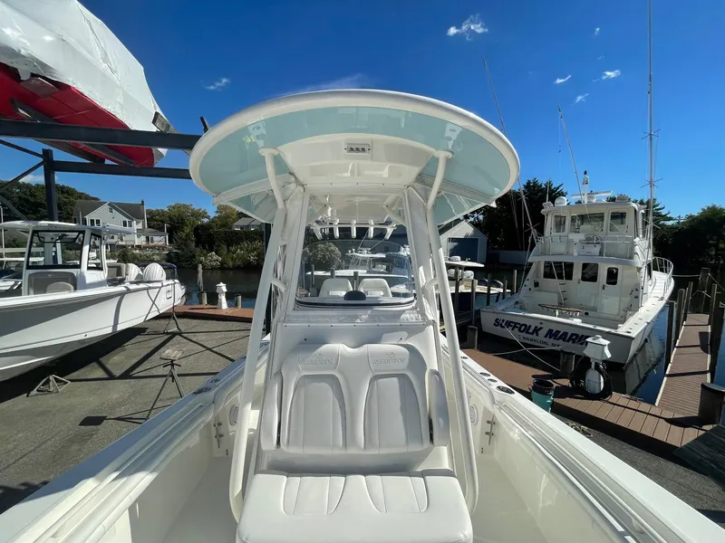 Slide: The Image of 2019 Regulator 23 boat docked, featuring a sleek design and spacious seating. - 21