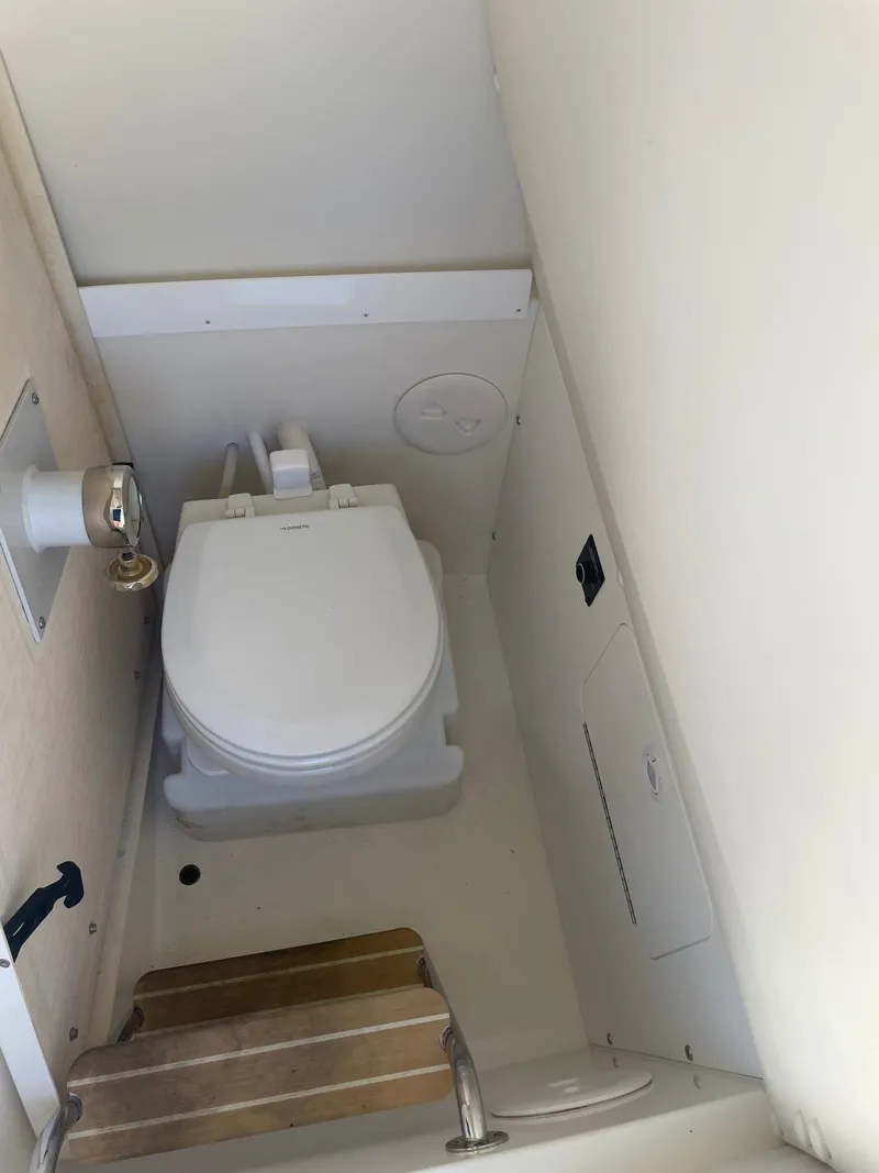 Slide: The Image of 2019 Regulator 23 boat interior with compact marine toilet. - 24
