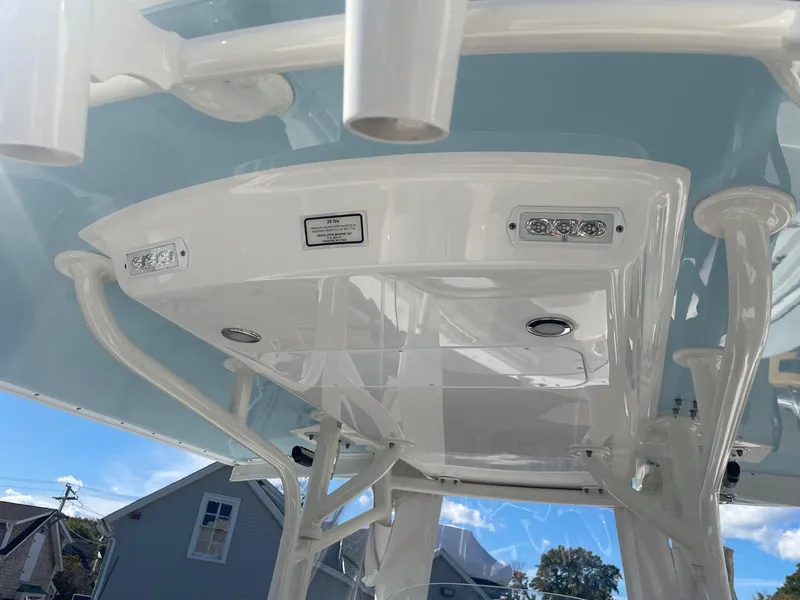 Slide: The Image of 2019 Regulator 23 boat T-top with integrated lights and rod holders. - 27