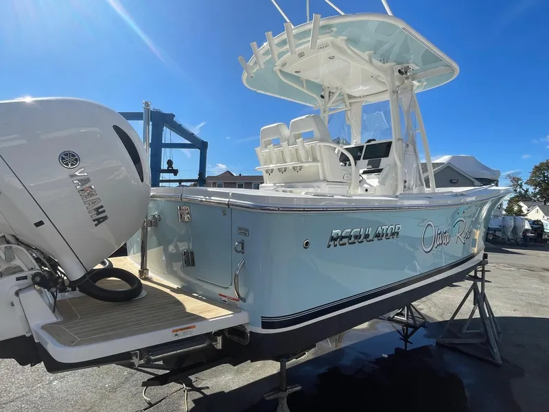 Slide: The Image of 2019 Regulator 23 boat with Yamaha engine, docked under clear blue sky. - 3