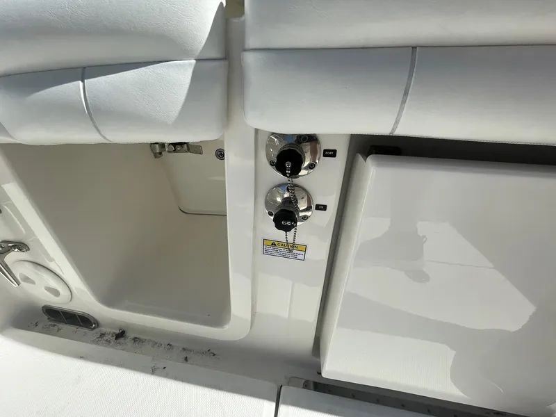 Slide: The Image of 2019 Regulator 23 boat interior with storage compartments and control knobs. - 30