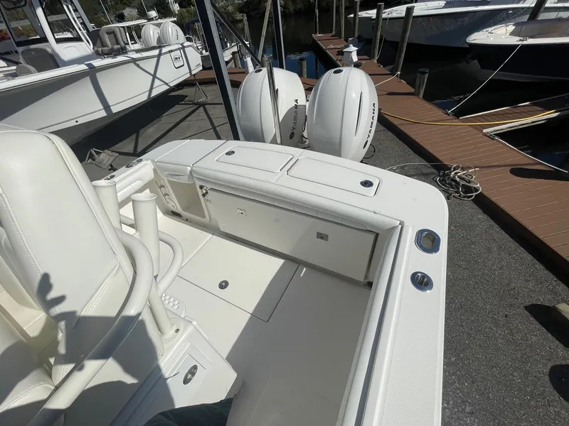 Slide: The Image of 2019 Regulator 23 boat with dual outboard engines docked at a marina. - 31
