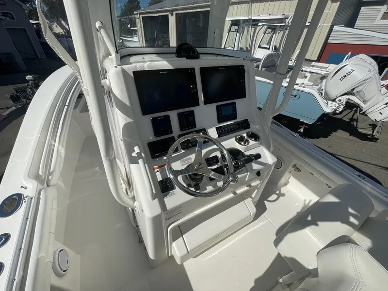 Slide: The Image of 2019 Regulator 23 boat cockpit with dual screens and steering wheel. - 34