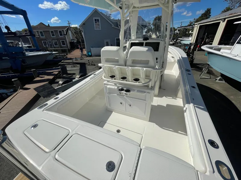 Slide: The Image of 2019 Regulator 23 boat with spacious deck and dual seating, docked in a marina. - 35