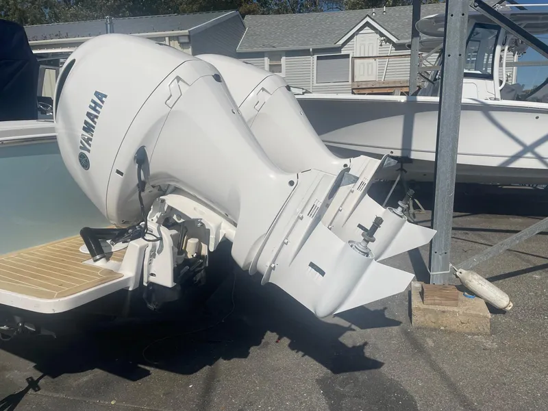 Slide: The Image of 2019 Regulator 23 boat with Yamaha outboard motor in a marina setting. - 37
