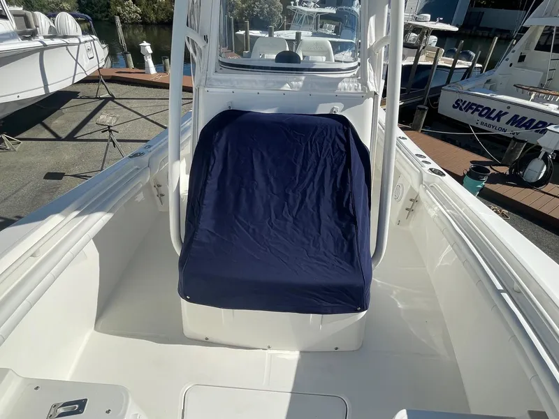 Slide: The Image of 2019 Regulator 23 boat interior with blue seat cover, docked at marina. - 38
