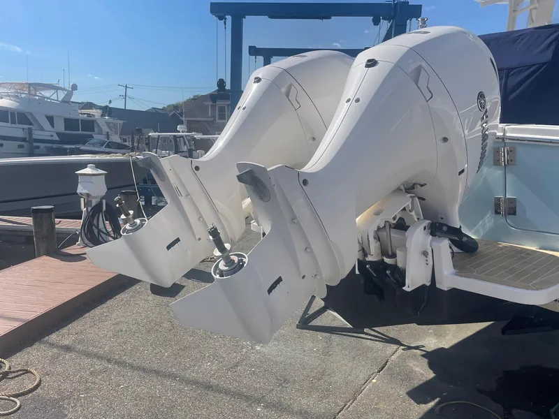 Slide: The Image of 2019 Regulator 23 boat with dual outboard engines at a marina. - 39