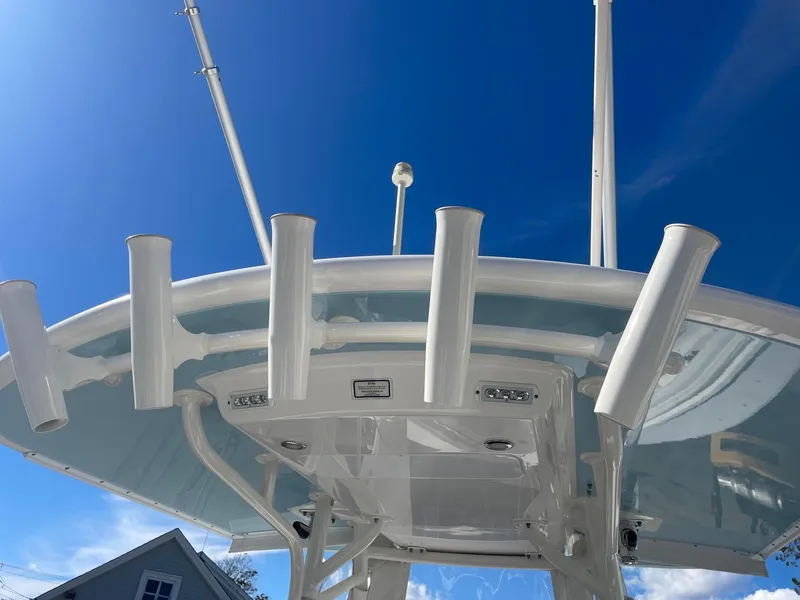 Slide: The Image of 2019 Regulator 23 boat with rod holders against a clear blue sky. - 42