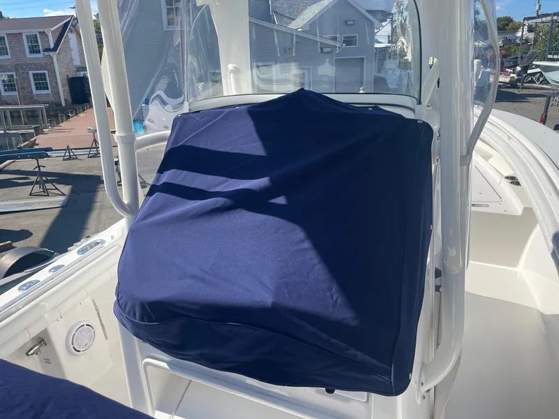 Slide: The Image of 2019 Regulator 23 boat with covered console, docked in a marina. - 44