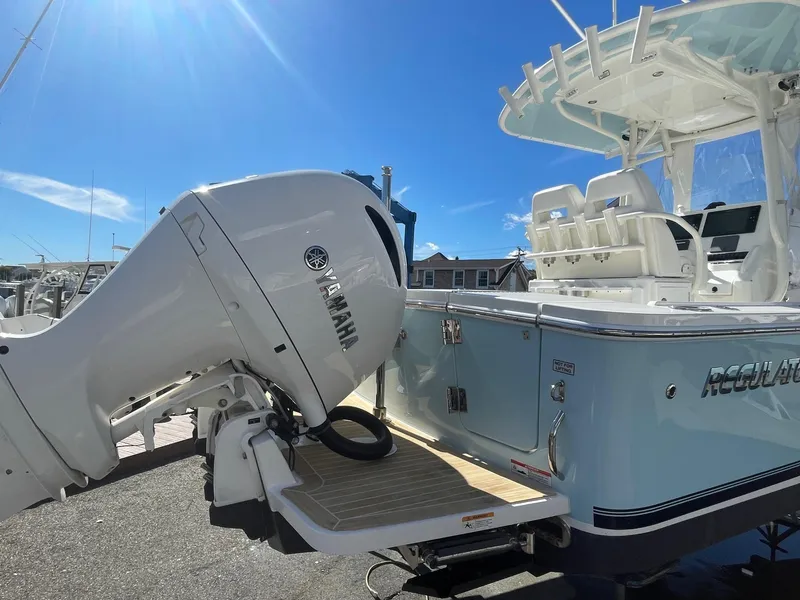 Slide: The Image of 2019 Regulator 23 boat with Yamaha outboard motor, docked under clear blue sky. - 5