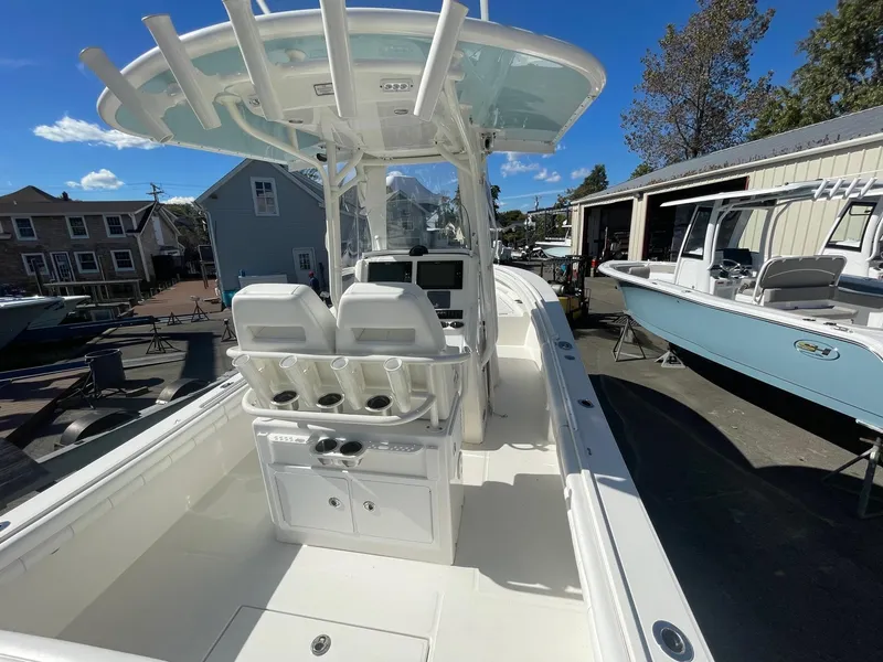 Slide: The Image of 2019 Regulator 23 boat with dual seats and center console in a marina setting. - 9