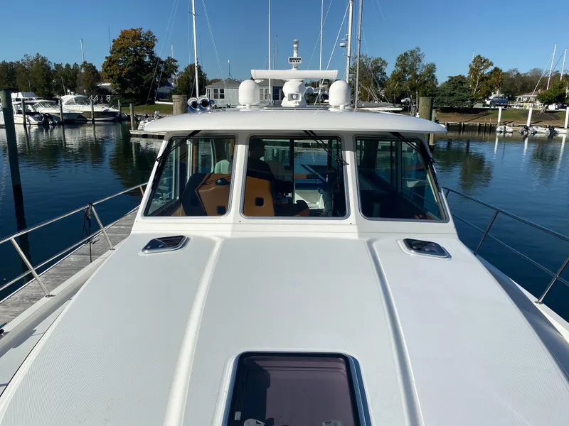 Slide: The Image of 2019 Sabre 45 Salon Express yacht docked under a covered marina. - 11