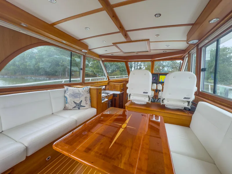 Slide: The Image of 2019 Sabre 45 Salon Express yacht docked, showcasing sleek exterior and glass doors. - 12