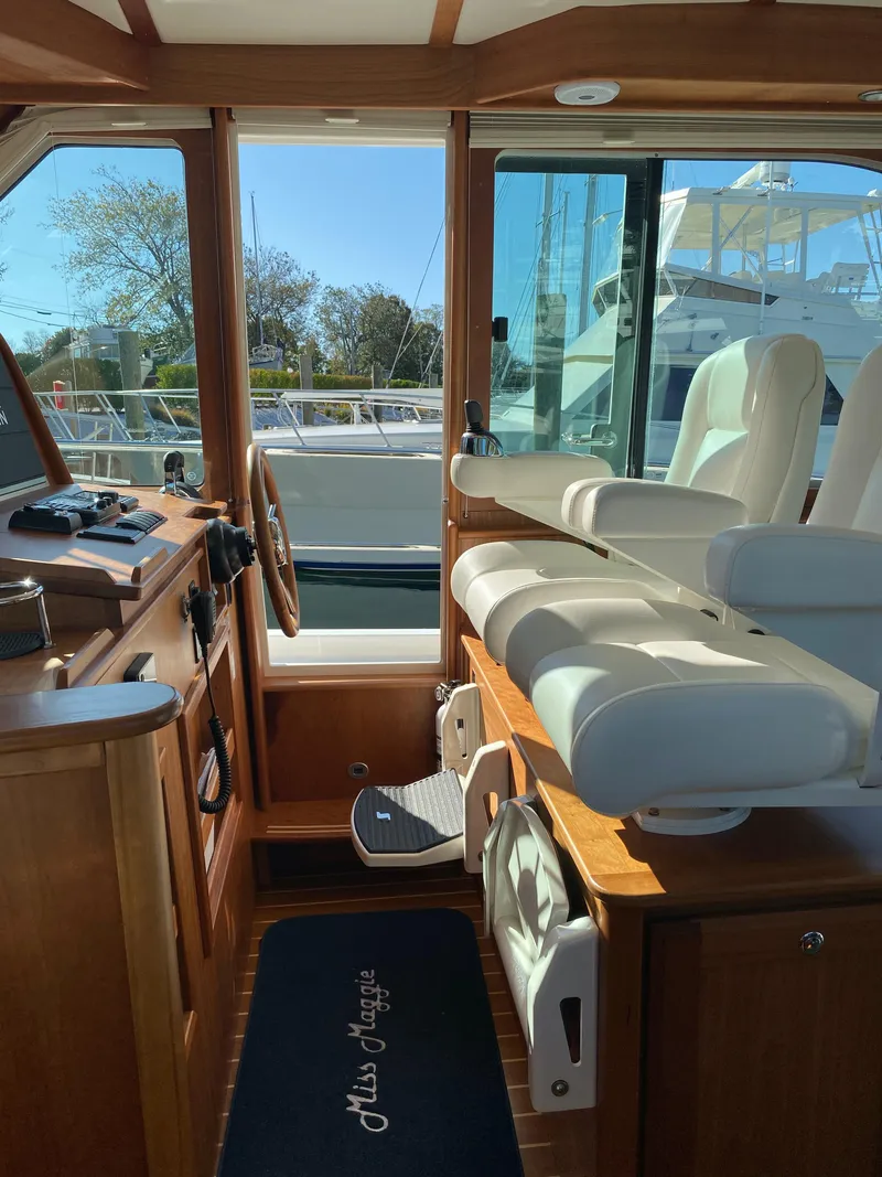 Slide: The Image of 2019 Sabre 45 Salon Express yacht, side view with blue seating and glass windows. - 13
