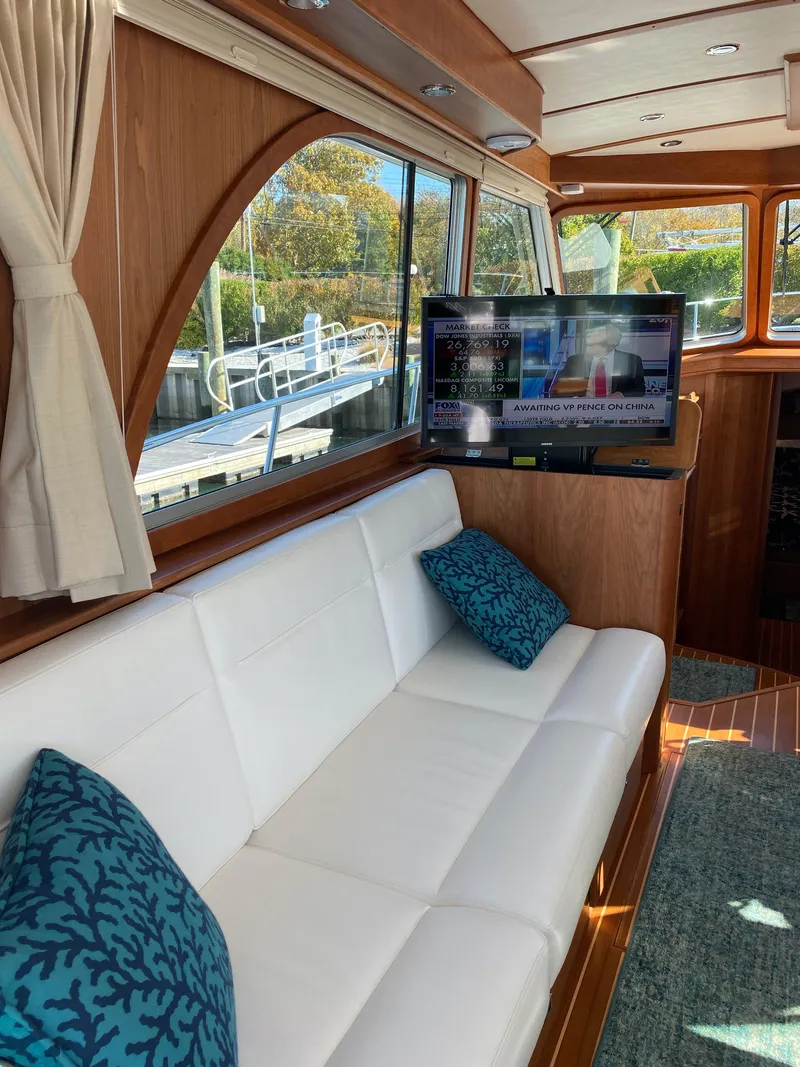 Slide: The Image of 2019 Sabre 45 Salon Express yacht docked in a marina, clear sky background. - 16