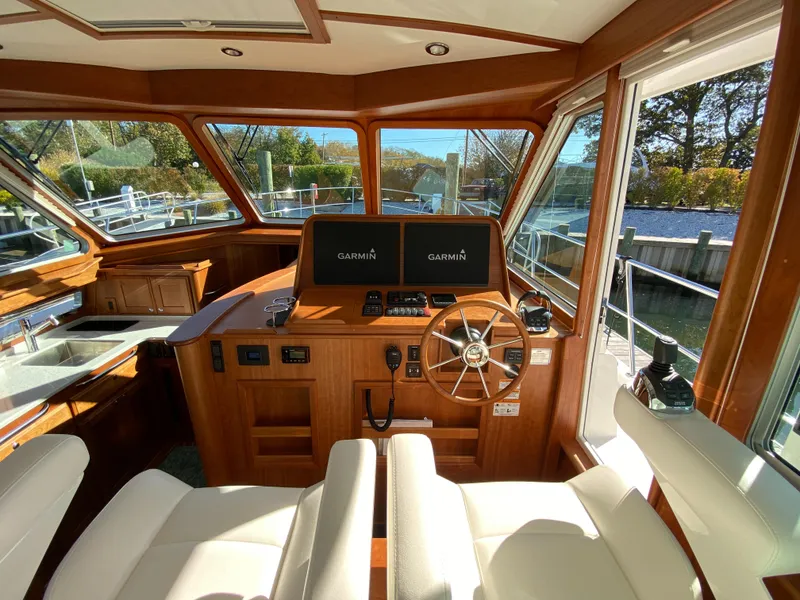Slide: The Image of Luxurious 2019 Sabre 45 Salon Express yacht interior with elegant wood finish and plush seating. - 19