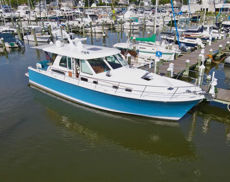 Slide: The Image of 2019 Sabre 45 Salon Express yacht docked in a marina. - 2