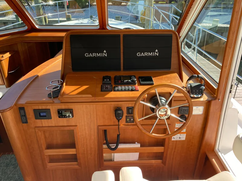 Slide: The Image of 2019 Sabre 45 Salon Express helm with navigation screens and wooden steering wheel. - 24