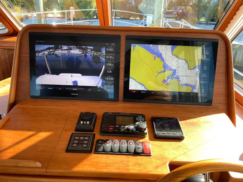Slide: The Image of 2019 Sabre 45 Salon Express helm with Garmin navigation displays and wooden steering wheel. - 26