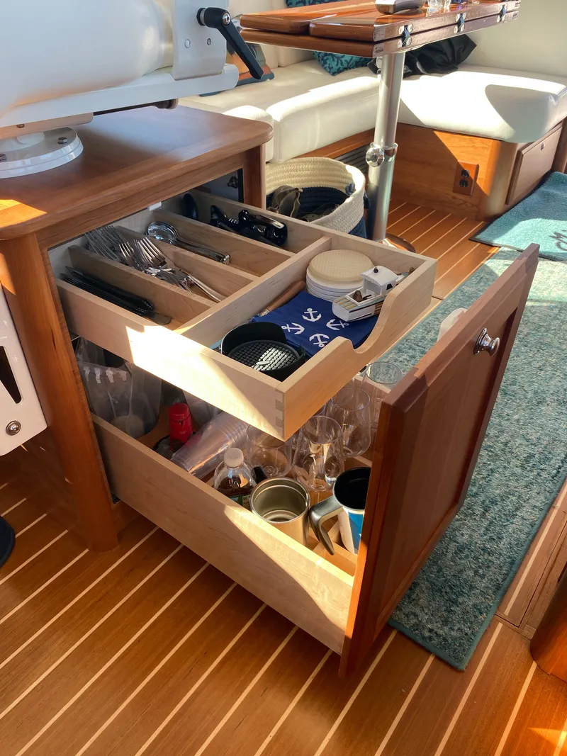 Slide: The Image of 2019 Sabre 45 Salon Express interior with white seating and blue cushions. - 28