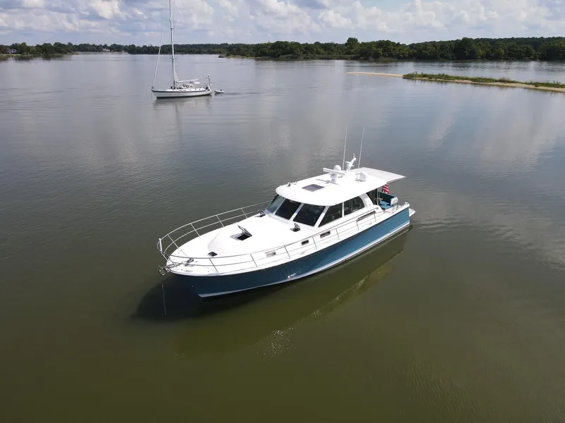 Slide: The Image of 2019 Sabre 45 Salon Express yacht on calm water, scenic background. - 3