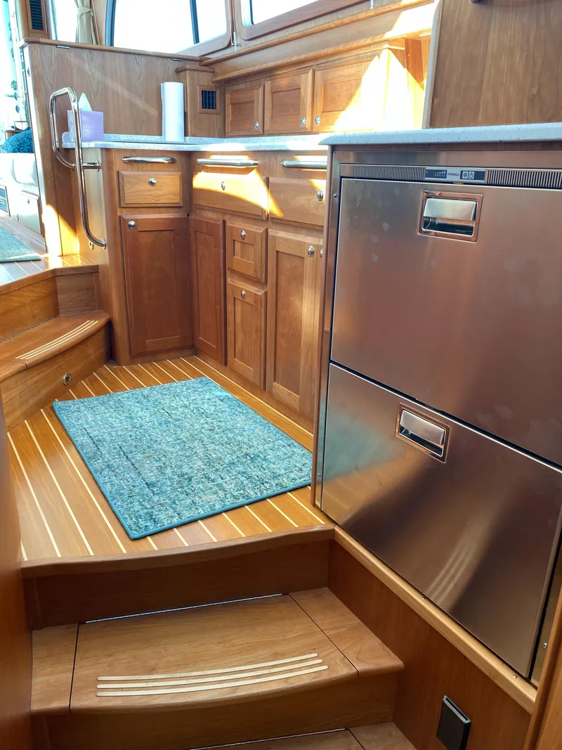 Slide: The Image of Interior of 2019 Sabre 45 Salon Express with open drawers showing utensils and kitchenware. - 33