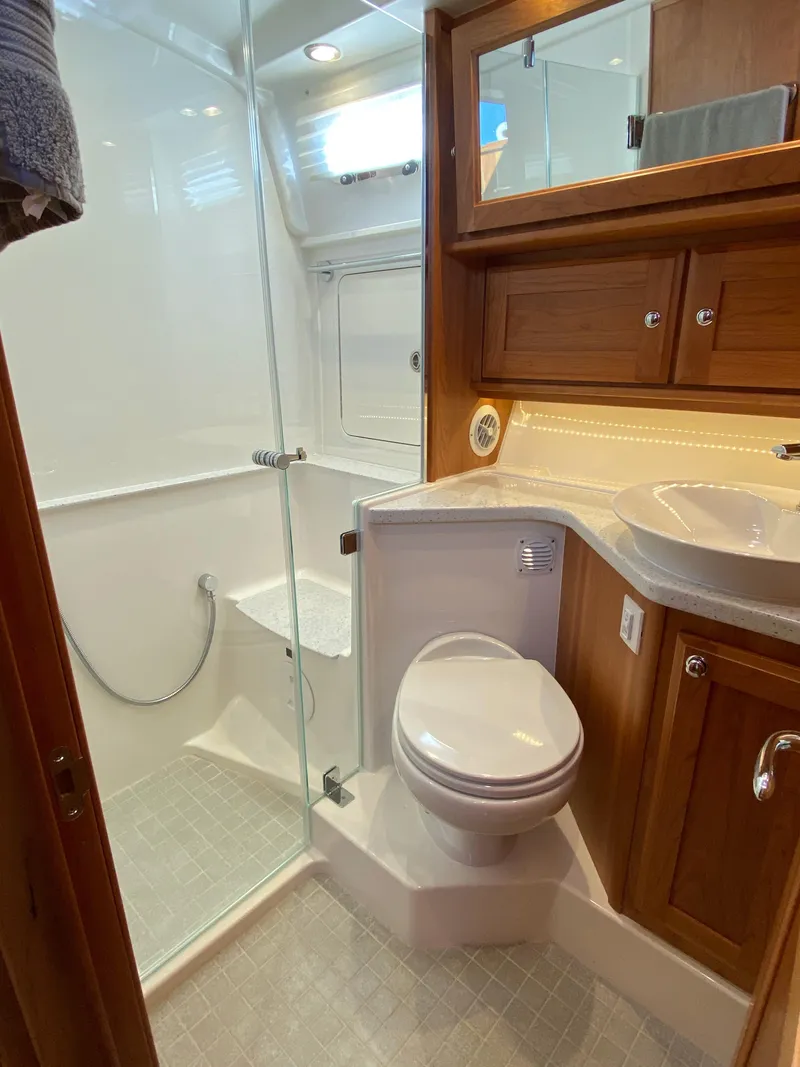 Slide: The Image of 2019 Sabre 45 Salon Express yacht kitchen with wood cabinetry and modern appliances. - 34