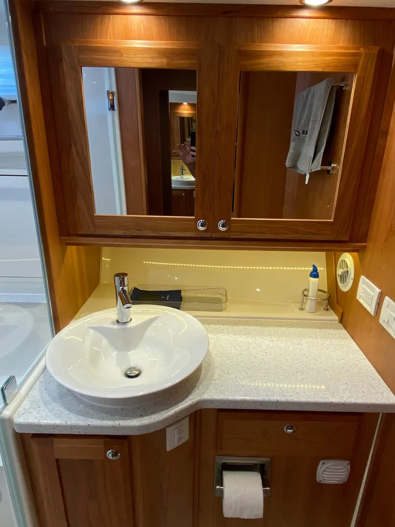 Slide: The Image of 2019 Sabre 45 Salon Express interior with wood cabinetry and stainless steel appliances. - 35