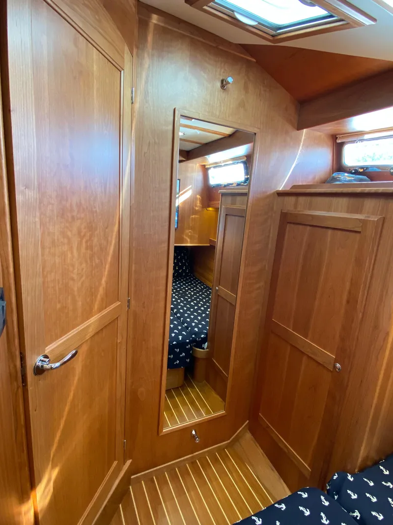 Slide: The Image of 2019 Sabre 45 Salon Express yacht kitchen with stove, sink, and wooden cabinetry. - 37