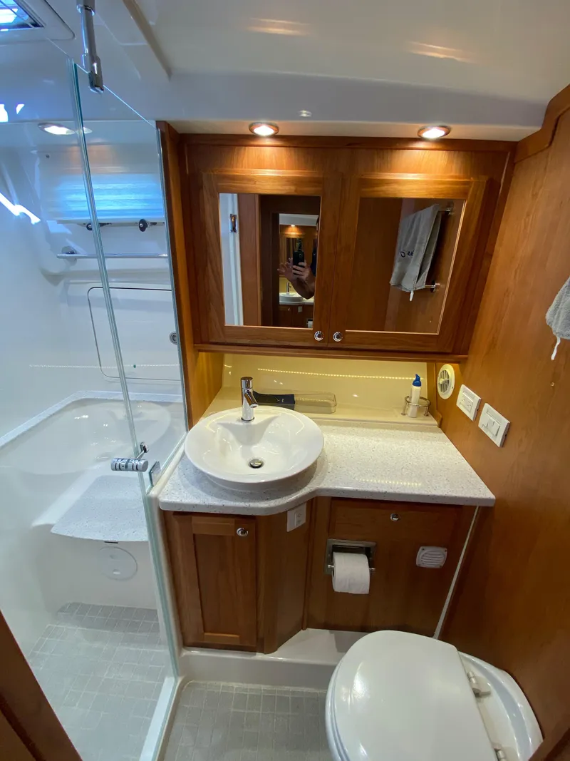 Slide: The Image of 2019 Sabre 45 Salon Express interior with wooden cabinetry and stainless steel appliances. - 38
