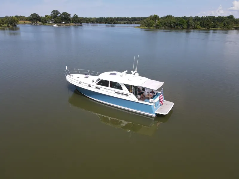 Slide: The Image of 2019 Sabre 45 Salon Express cruising on a serene lake. - 4