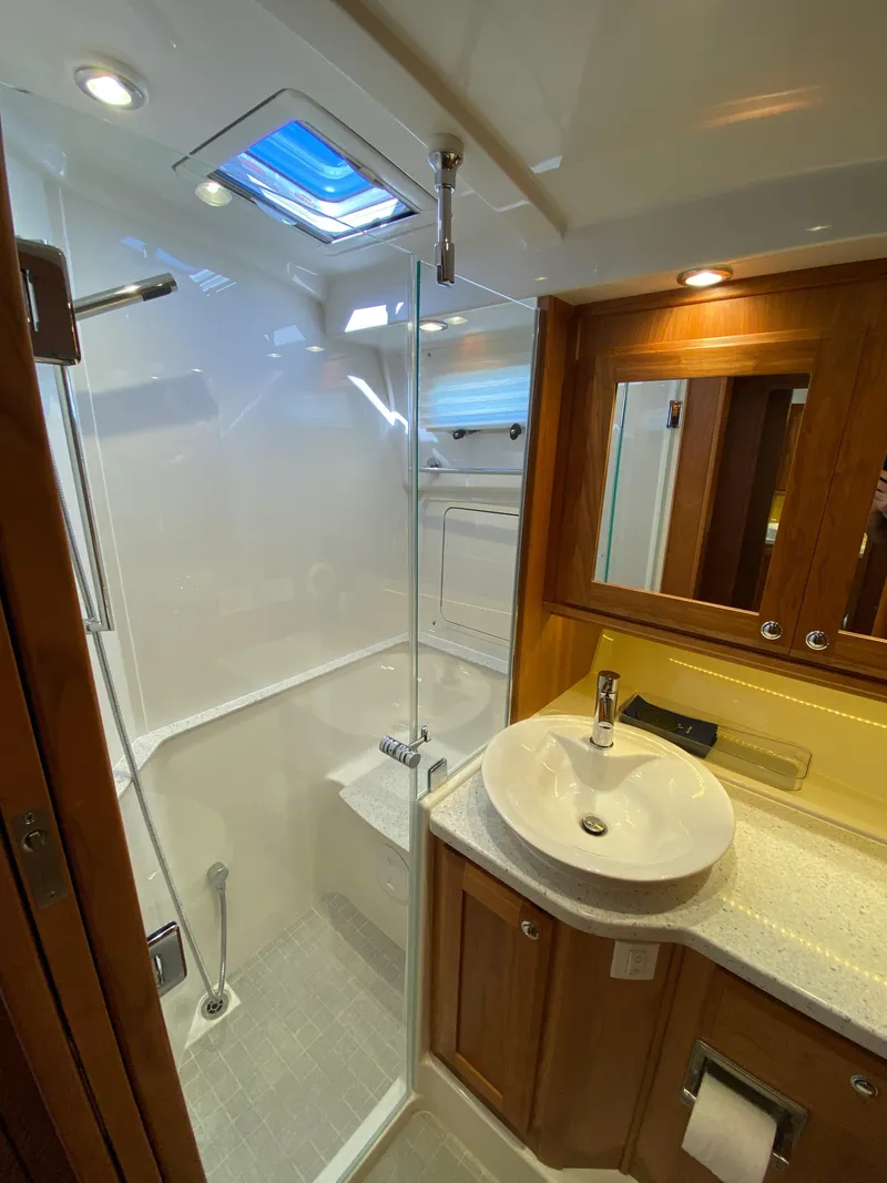 Slide: The Image of Luxurious bathroom in 2019 Sabre 45 Salon Express yacht with wood cabinetry and modern fixtures. - 43