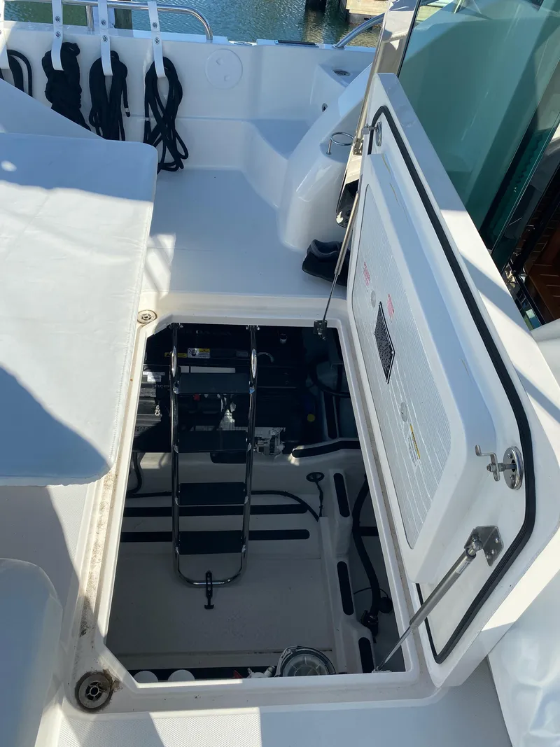 Slide: The Image of Open storage cabinet on 2019 Sabre 45 Salon Express boat, containing various items. - 52