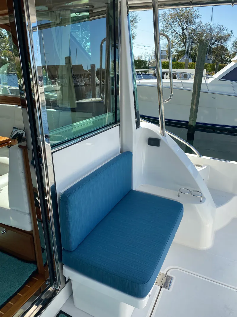 Slide: The Image of 2019 Sabre 45 Salon Express yacht with teak deck, seating area, and American flag. - 7