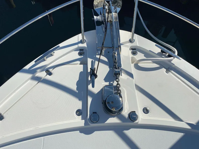 Slide: The Image of 2019 Sabre 45 Salon Express yacht with outdoor seating and American flag at dock. - 8