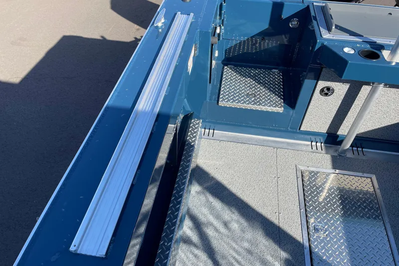 Slide: The Image of 2026 Hewescraft 210 Sea Runner ET interior with diamond plate flooring and blue accents. - 11