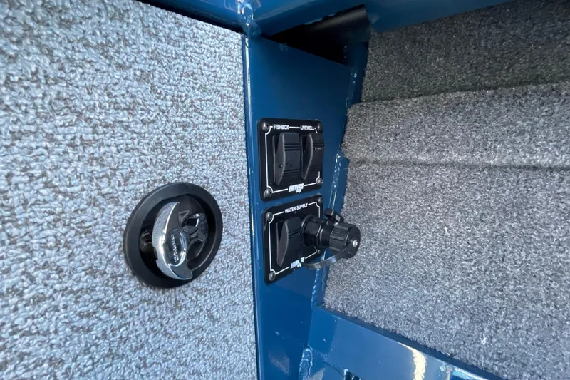 Slide: The Image of Interior controls of 2026 Hewescraft 210 Sea Runner ET boat, featuring switches and textured surfaces. - 12