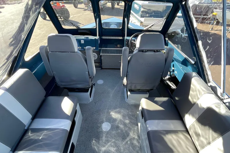 Slide: The Image of Interior of 2026 Hewescraft 210 Sea Runner ET boat with seating and steering console. - 17