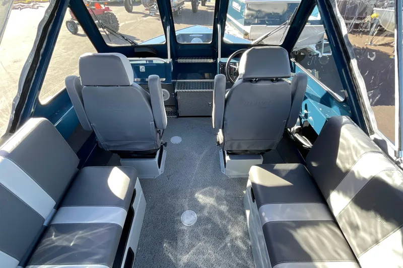 Slide: The Image of Interior of 2026 Hewescraft 210 Sea Runner ET boat with seating and steering console. - 18