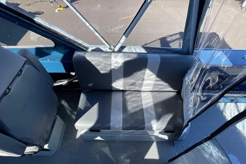 Slide: The Image of Interior seating of 2026 Hewescraft 210 Sea Runner ET boat, featuring gray upholstery. - 19