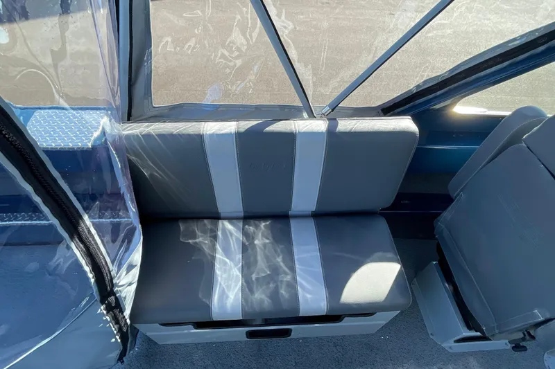 Slide: The Image of Interior seating of 2026 Hewescraft 210 Sea Runner ET boat, featuring gray and white upholstery. - 20