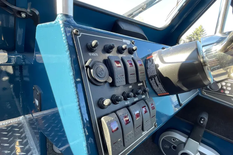 Slide: The Image of Control panel of 2026 Hewescraft 210 Sea Runner ET boat, featuring switches and steering wheel. - 25