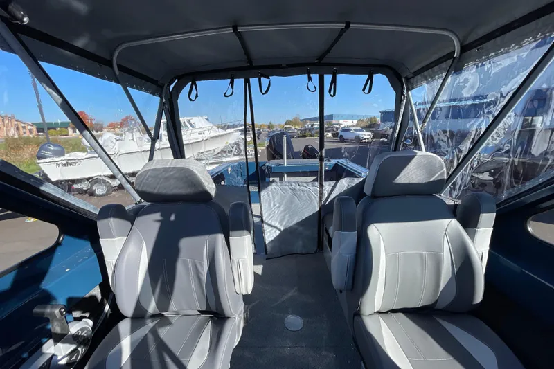 Slide: The Image of 2026 Hewescraft 210 Sea Runner ET interior with two gray seats and clear canopy. - 27