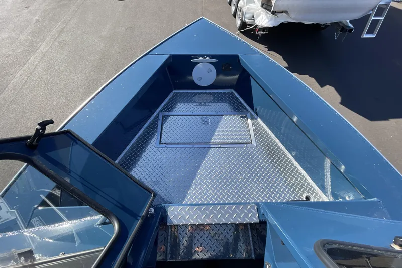 Slide: The Image of 2026 Hewescraft 210 Sea Runner ET boat with diamond plate deck, open hatch, and blue exterior. - 28