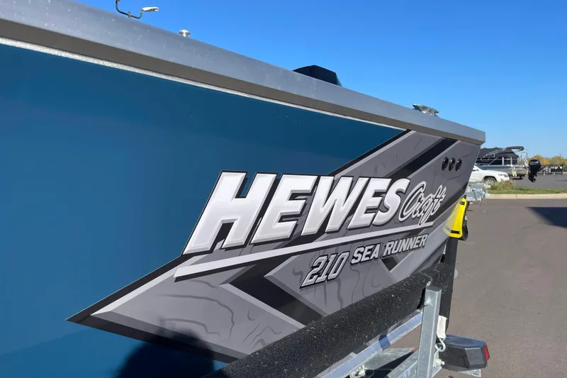 Slide: The Image of 2026 Hewescraft 210 Sea Runner ET boat with sleek design and bold graphics. - 31