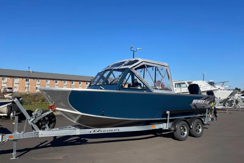 Slide: The Image of 2026 Hewescraft 210 Sea Runner ET boat on trailer under clear blue sky. - 4